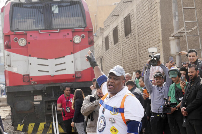 A Wrestler from Egypt Attempts to set a World Record by Pulling 20 Automobiles